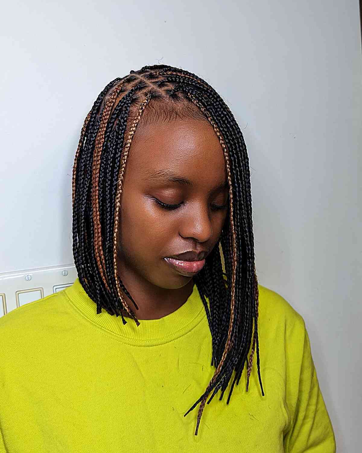 A long, asymmetric bob with small braids without knots and colored