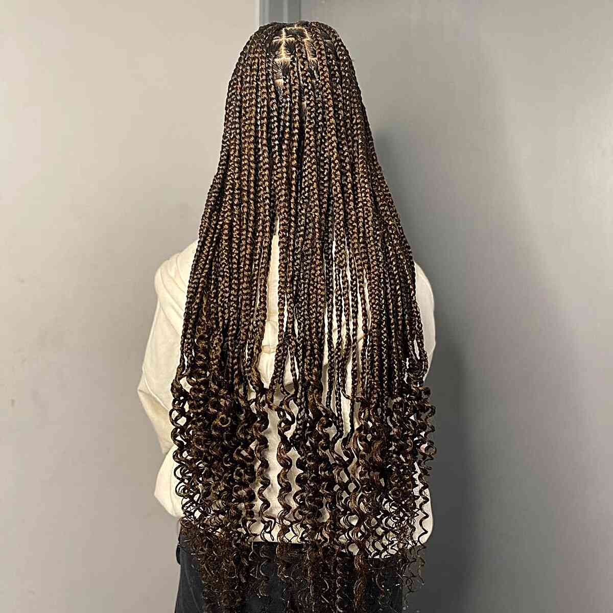 Small braids of dark brown length with curls on the ends