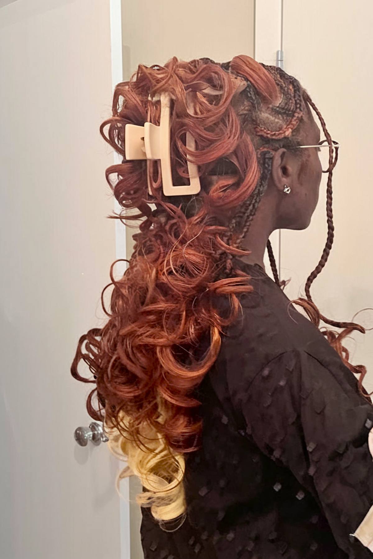 French red curls with a clutch clip and blonde tips