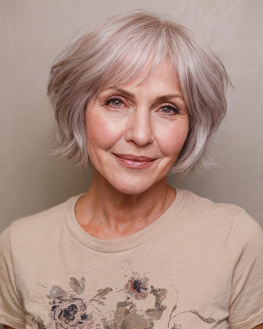 Choppy layered bob with wispy bangs for women over 60 with fine silver hair