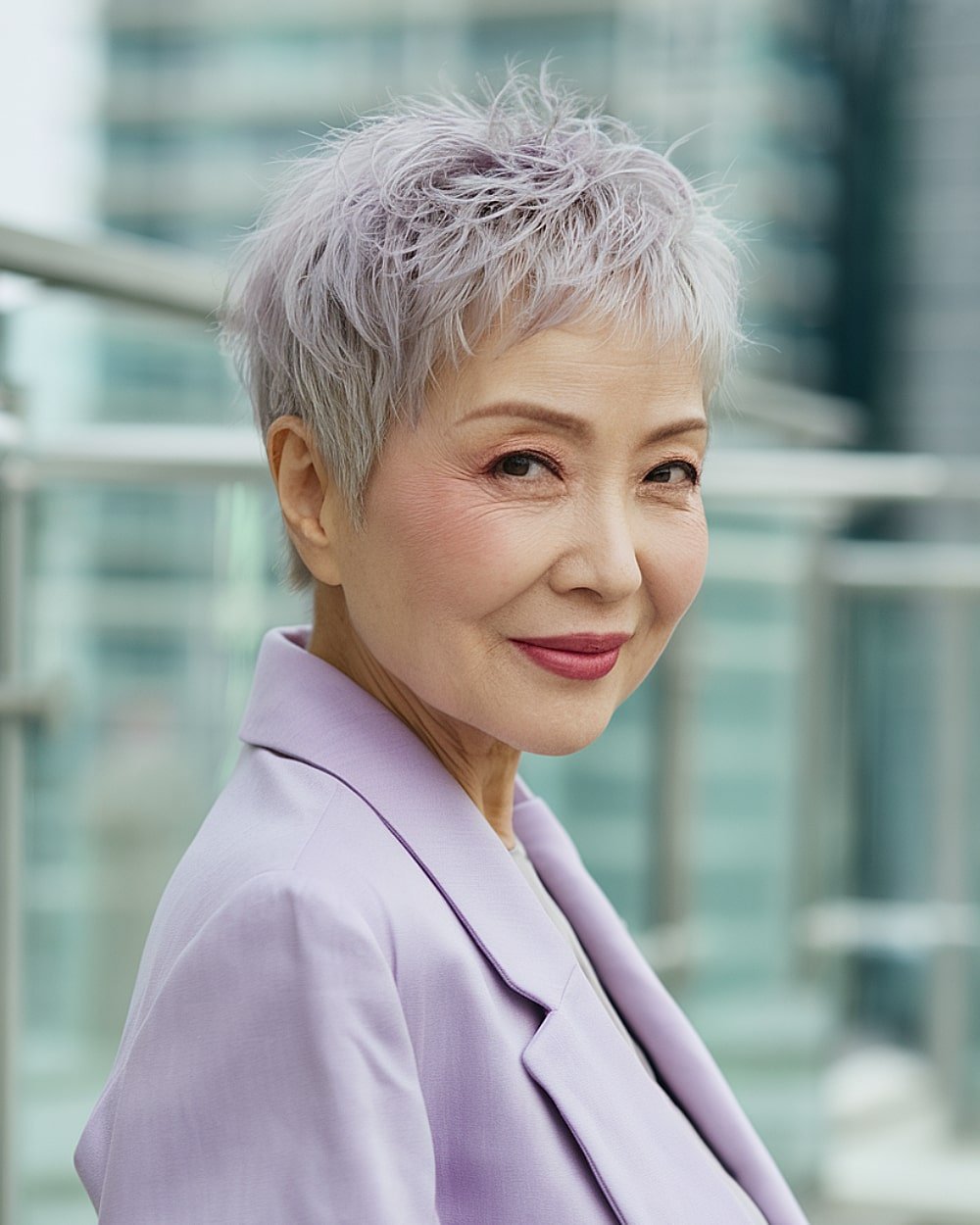 Short feathered pixie for fine silver hair over 60 with textured crown and tapered sides