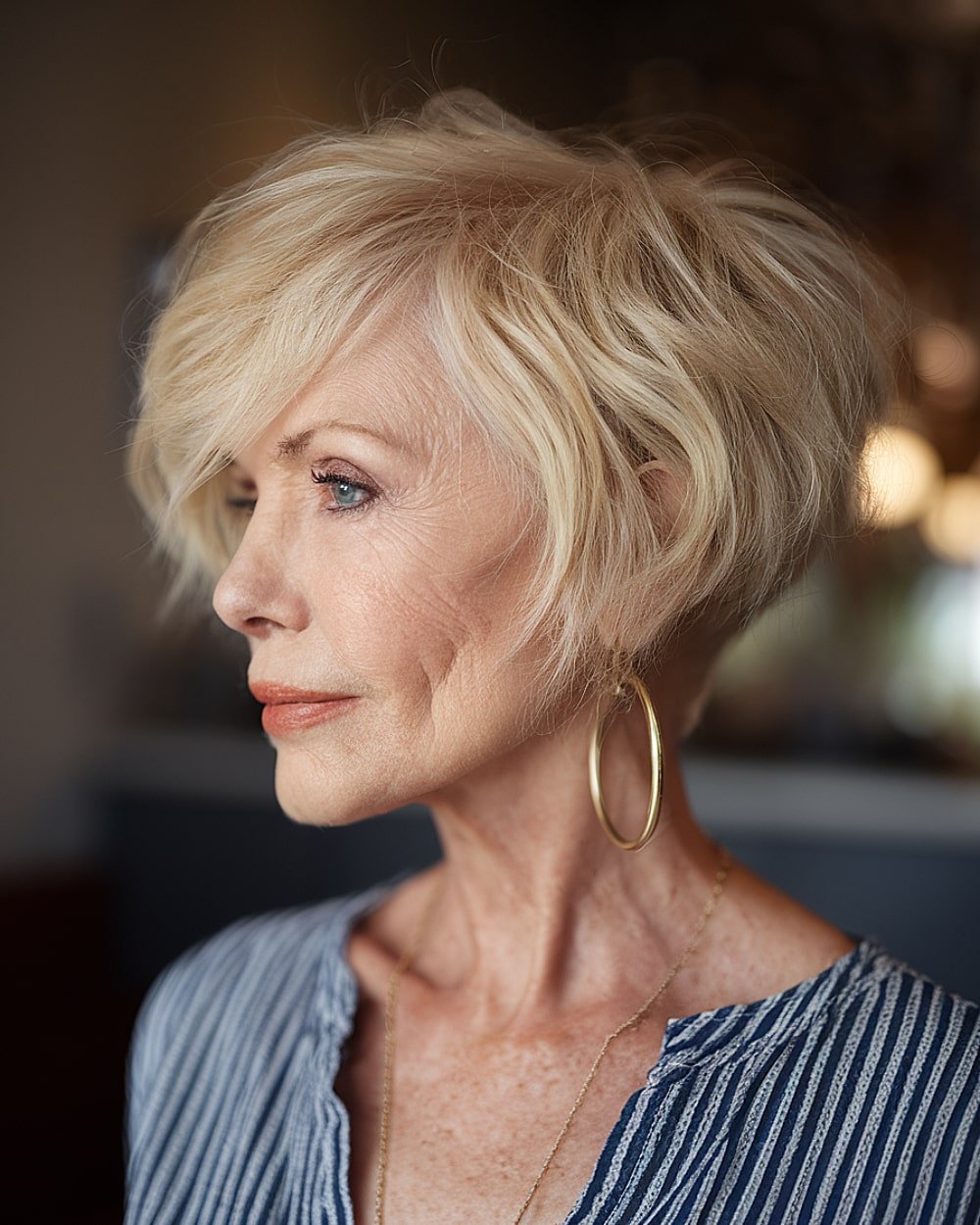 Champagne blonde wedge haircut with side-swept bangs for women over 60 with fine hair