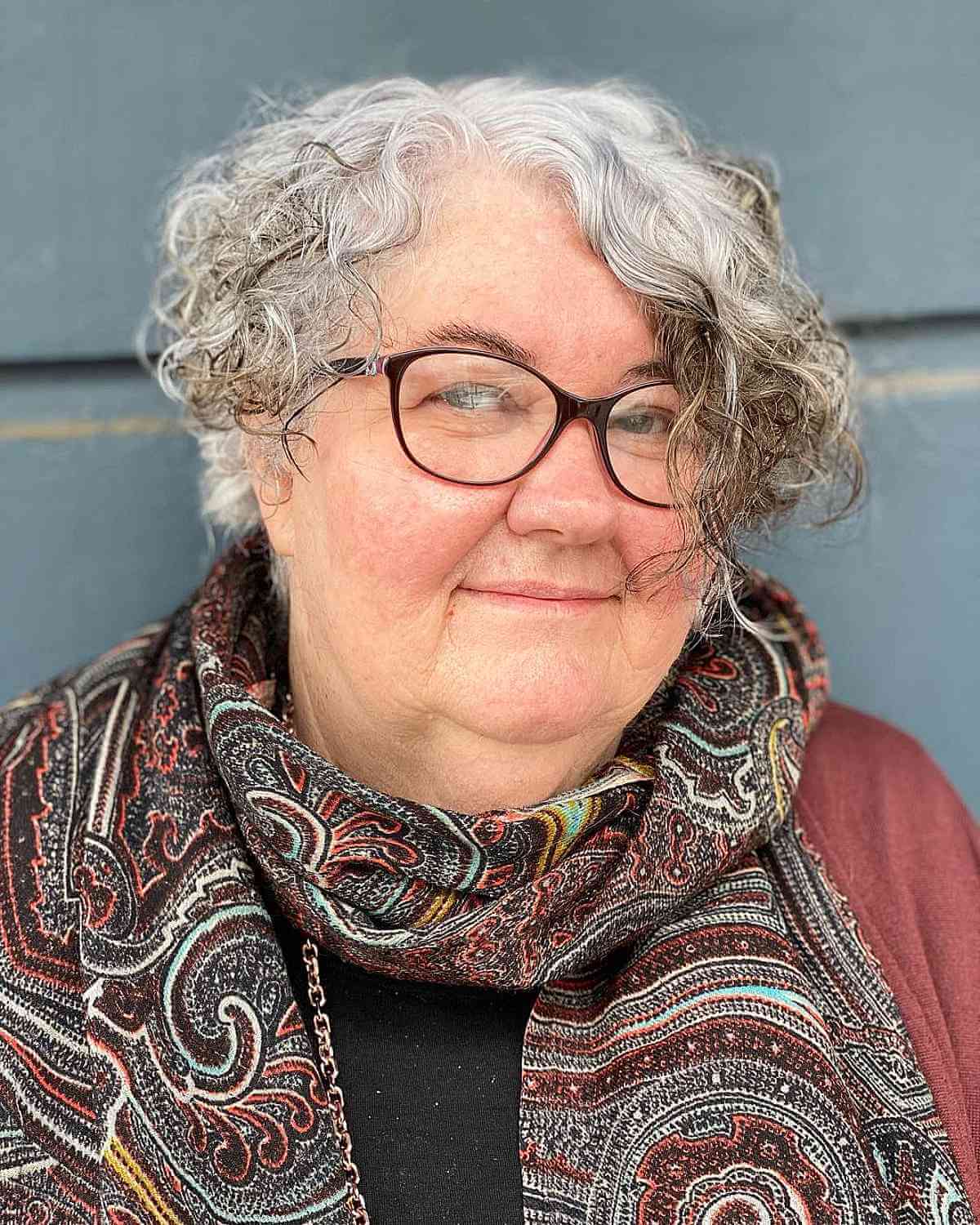 Asymmetrical Curly Haircut for Round Faces for 60-Year-Olds