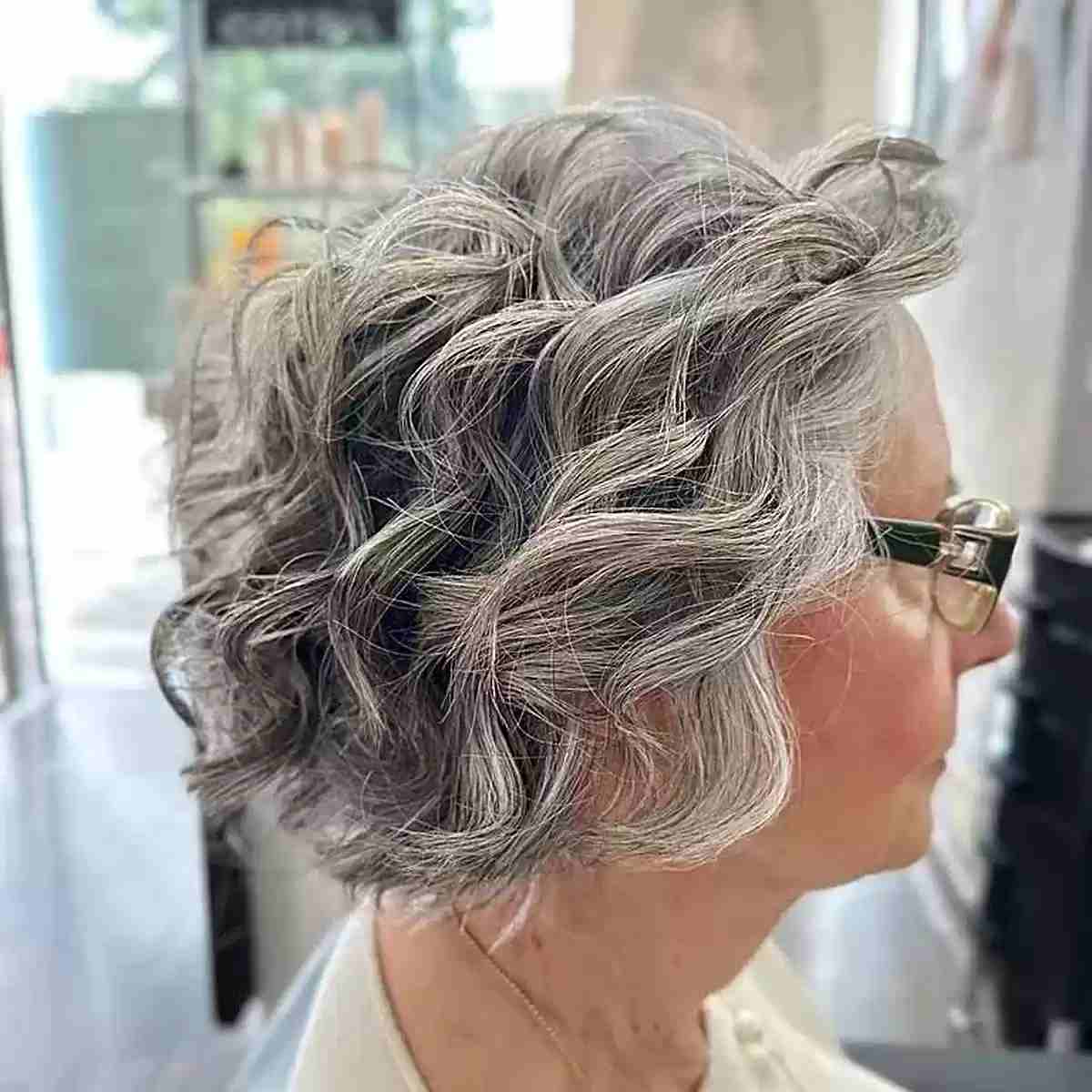 Chin-Grazing Voluminous Wavy Bob Hairstyle on Senior Ladies Over Sixty
