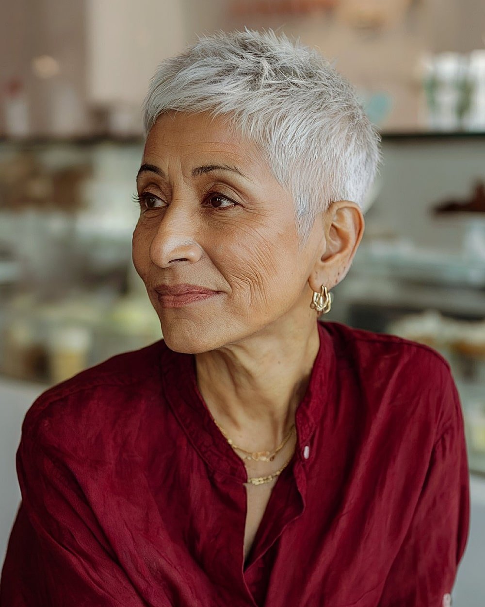 Ultra short textured pixie cut for thinning hair over 60 with a clean tapered neckline