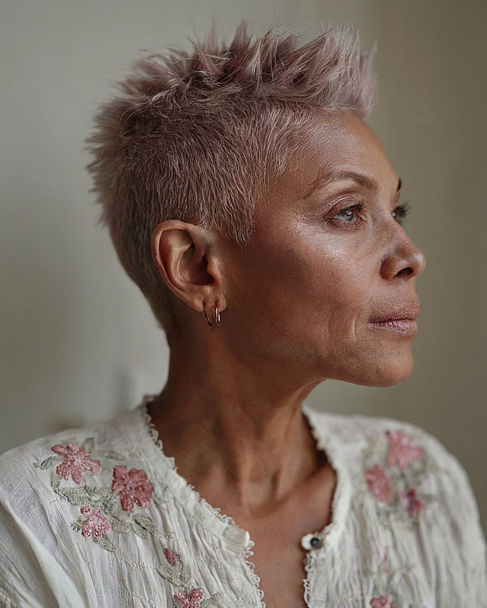 Edgy tapered mauve pixie cut with choppy spikes for bold women over 60