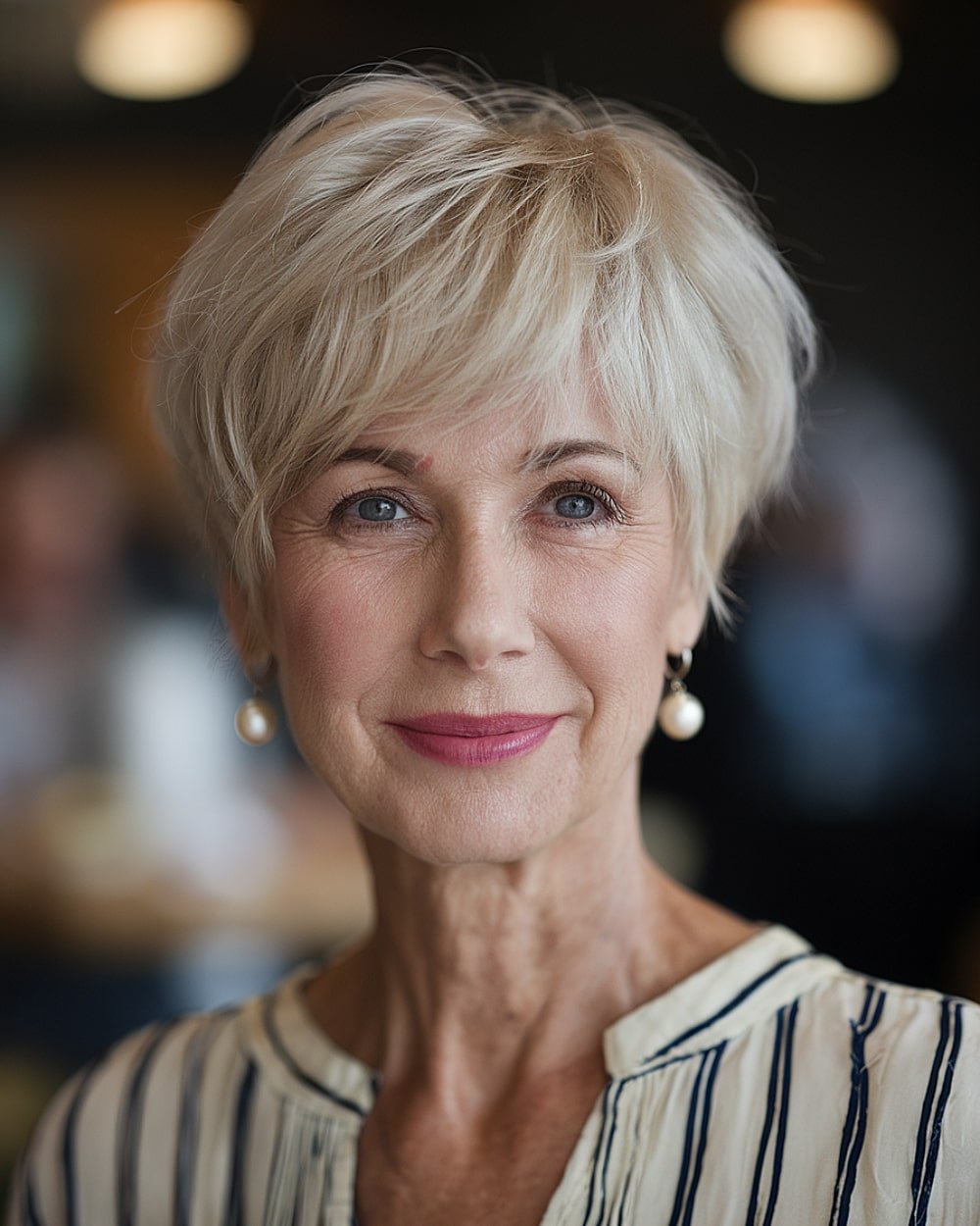 Short icy blonde crop with soft wispy fringe for mature women over 60