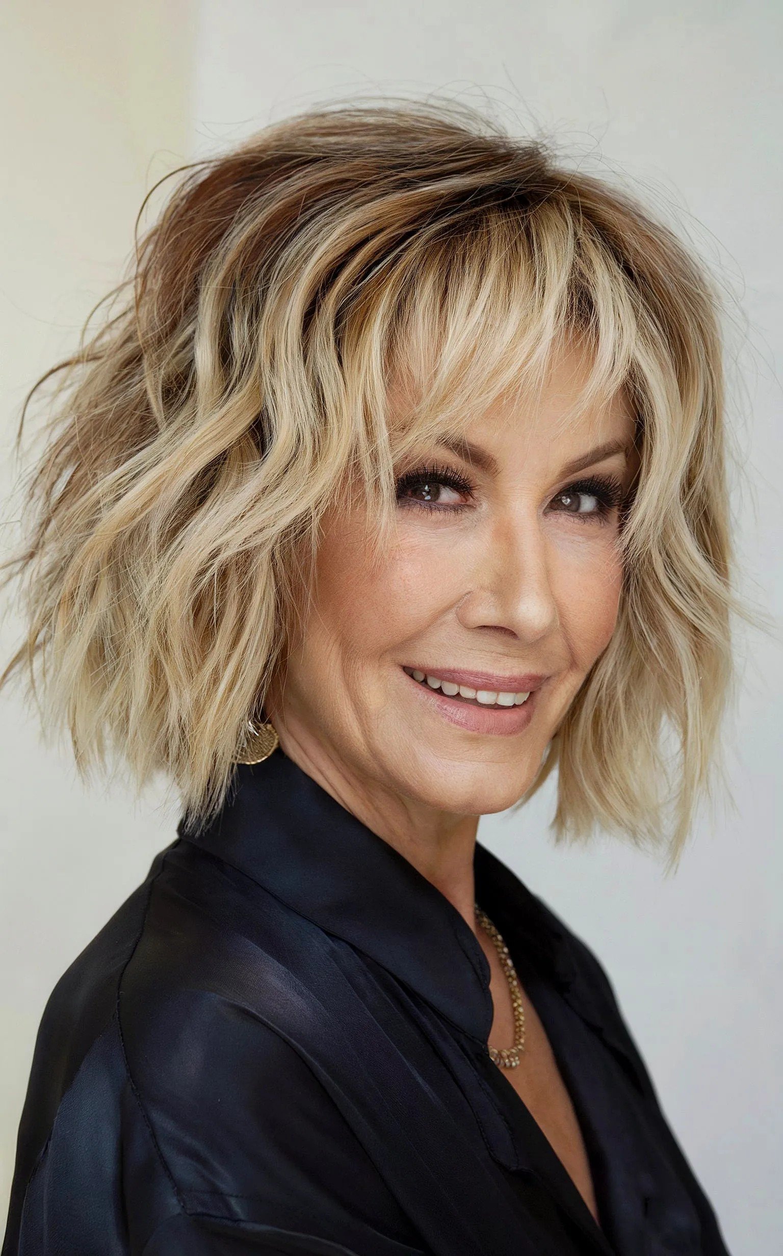 Neck-Length Rooted Blonde Wavy Choppy Bob for 60-year-olds