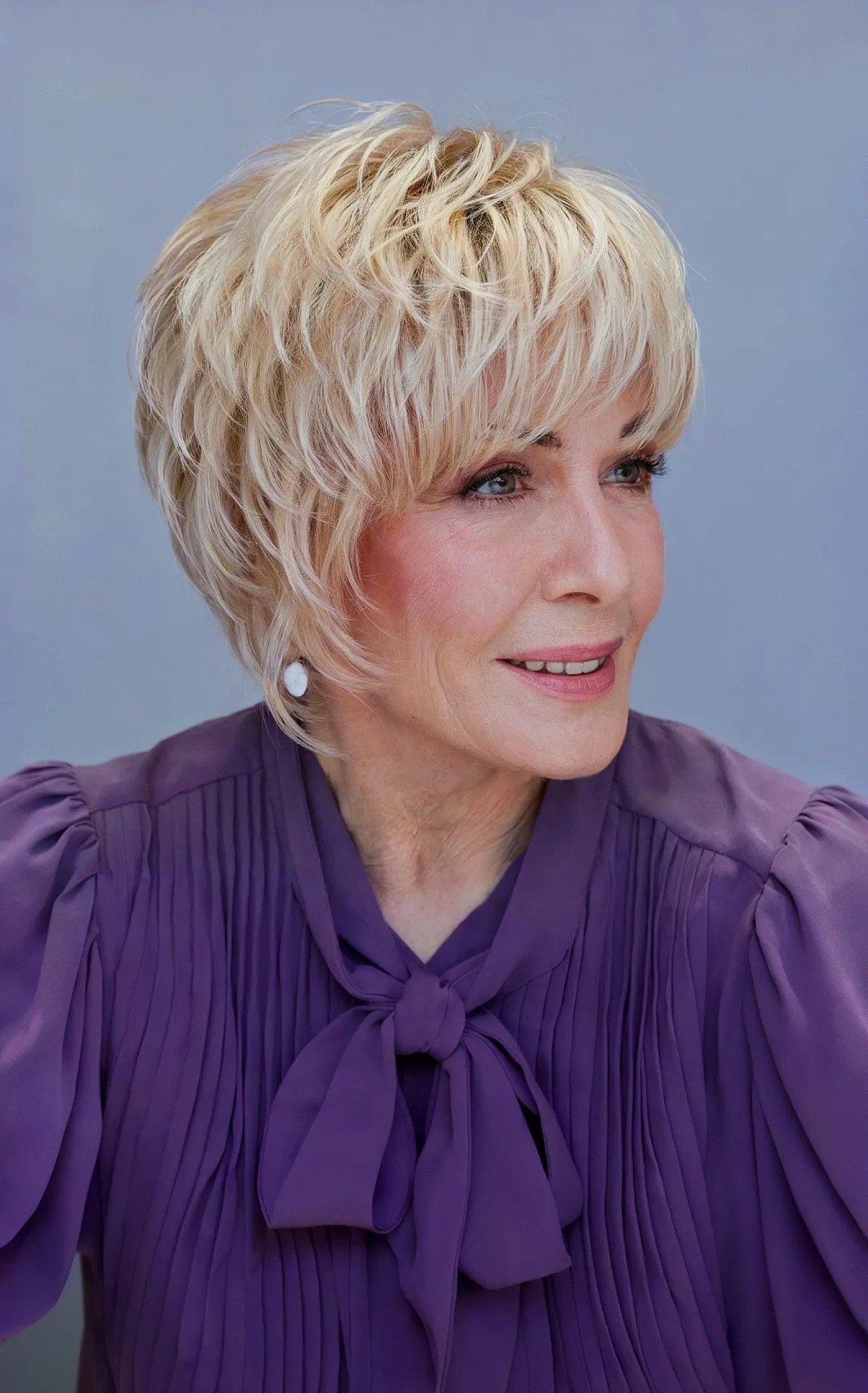 Cheek-length Textured Pixie with Choppy Layers and Bangs for 60-year-olds