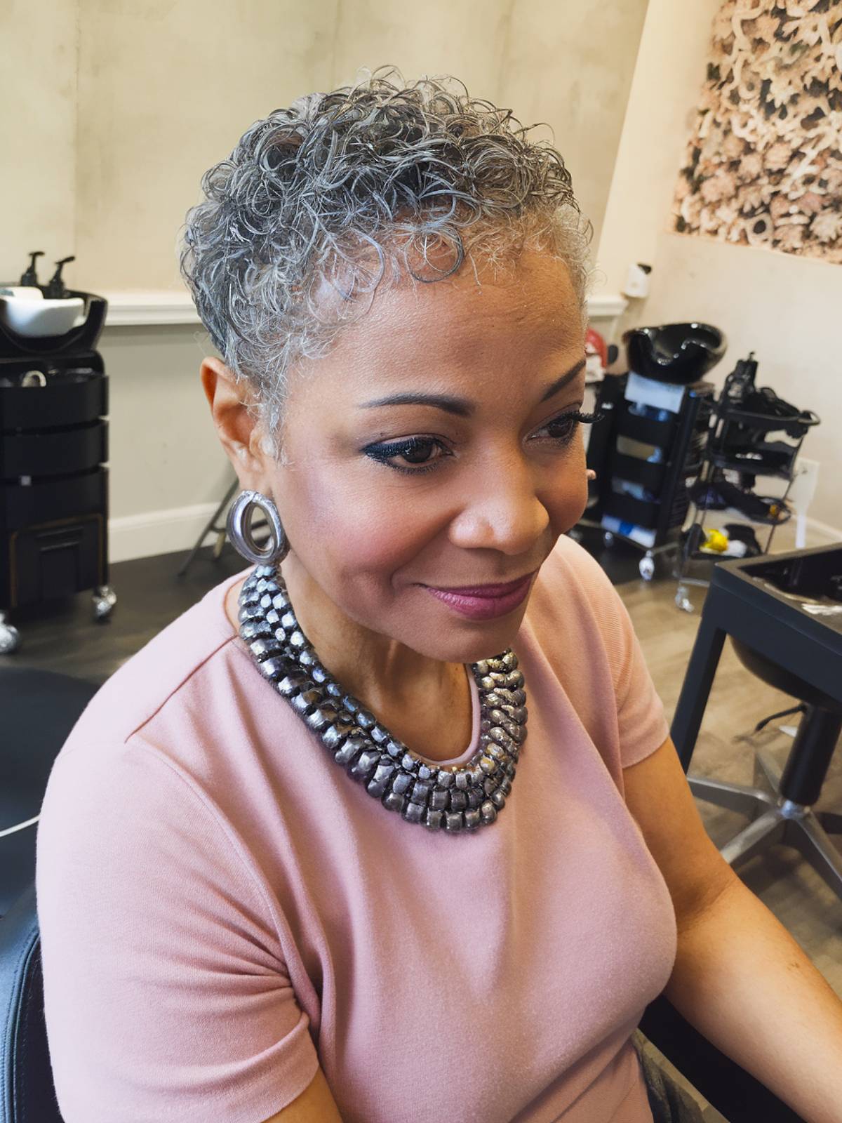 A short or pointed natural haircut for black women over 60 years