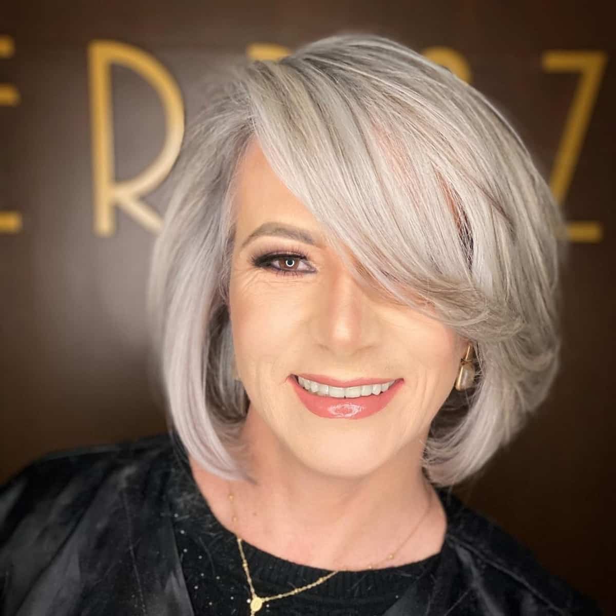 Long bob with side-swept bangs for women 60+