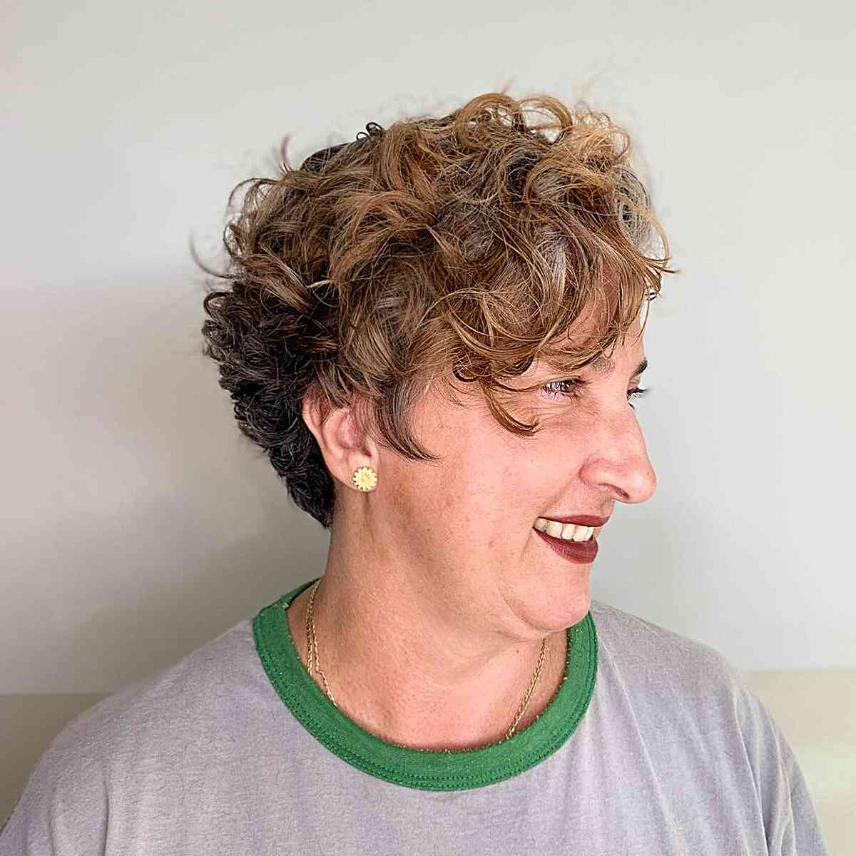Short Messy Pixie with Piece-y Layers and Curls for 50-year-old Ladies