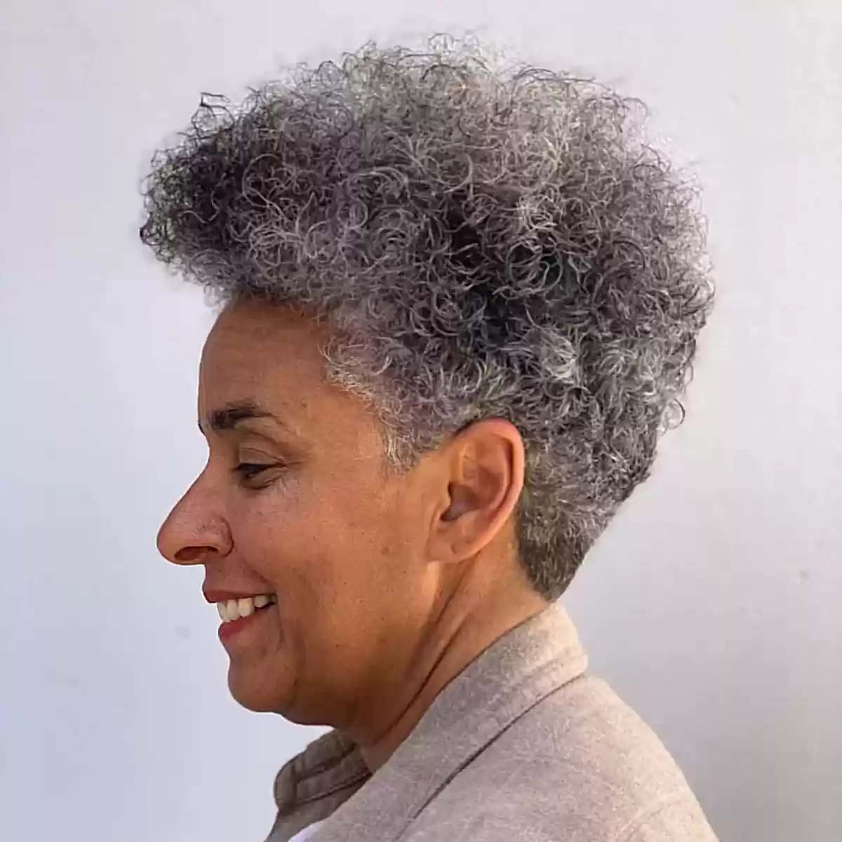 Edgy Curly Haircut with Short Nape and Long Top for Old Women with Salt and Pepper Hair