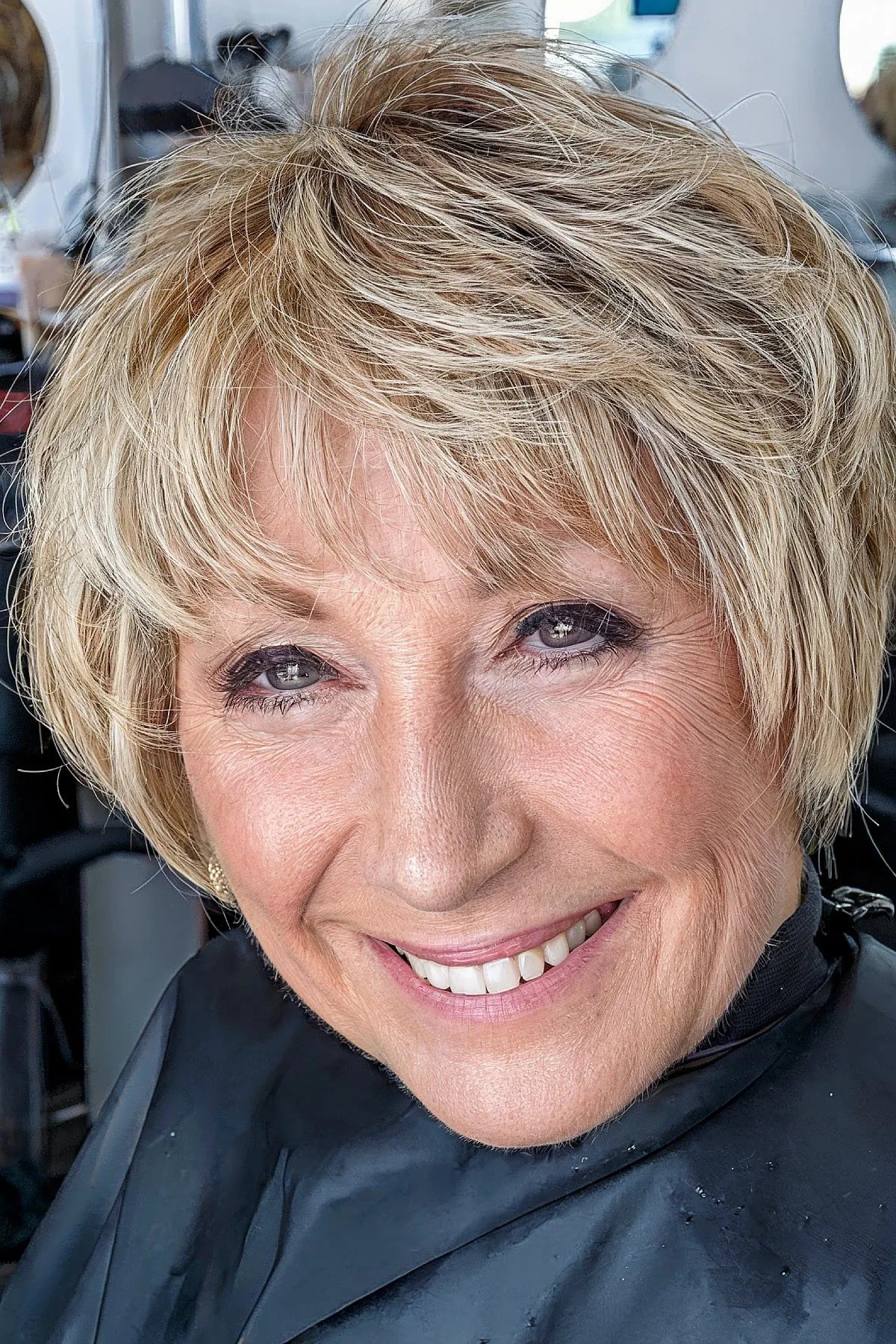 Short Bob with Bangs and Soft Blonde Tones for 60-year-olds