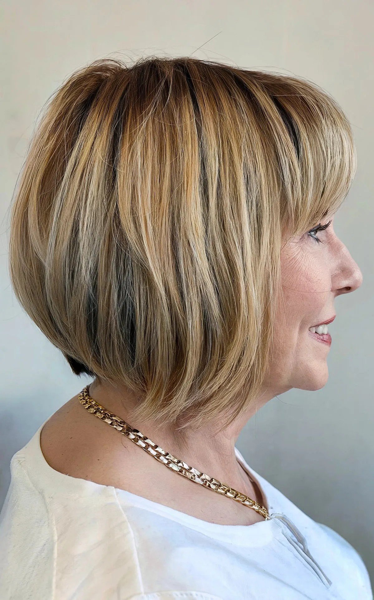 Caramel Balayage on a Short Bob with Bangs for Ladies Over 60