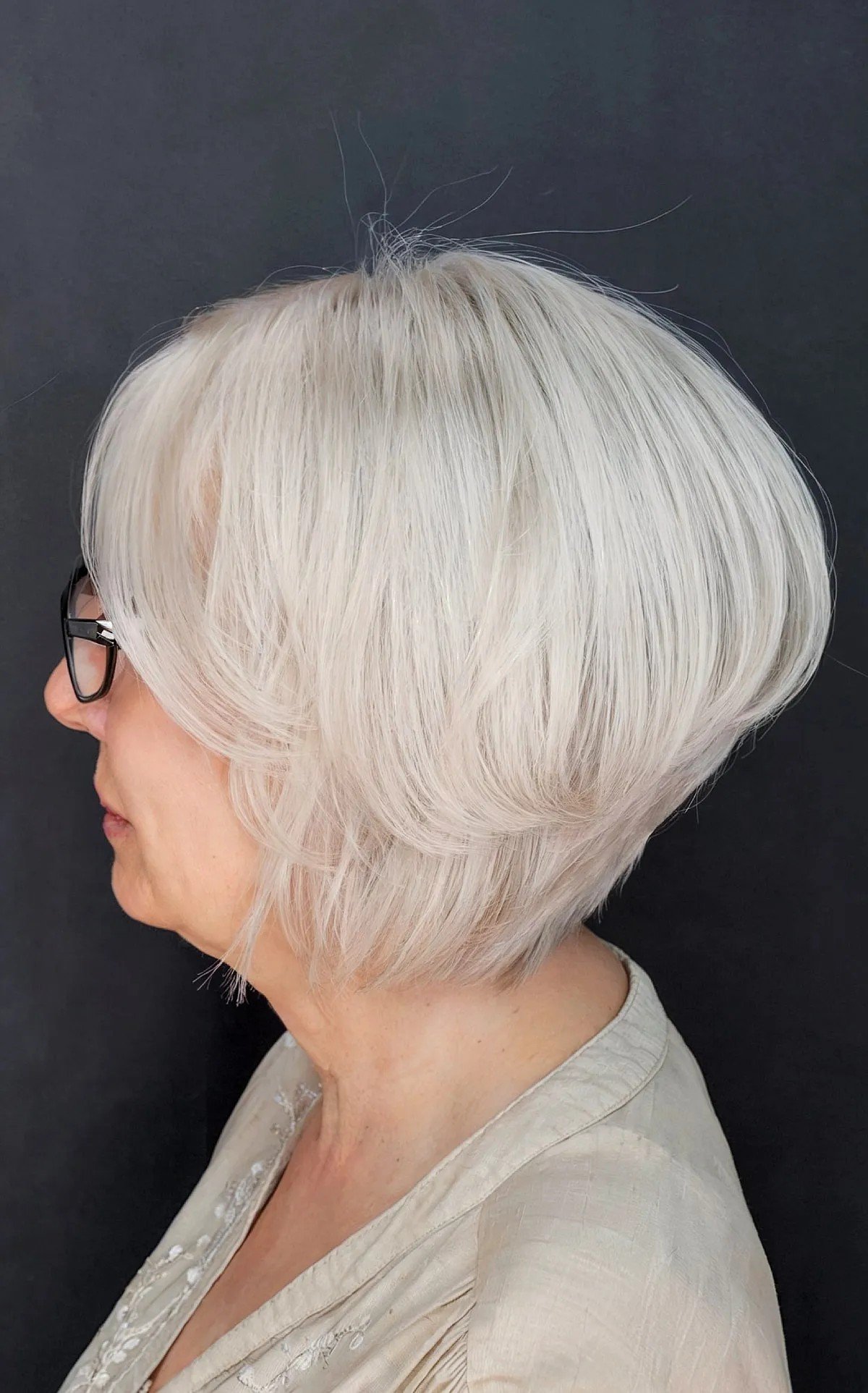 Chin-length graduated bob for women over 60 with glasses