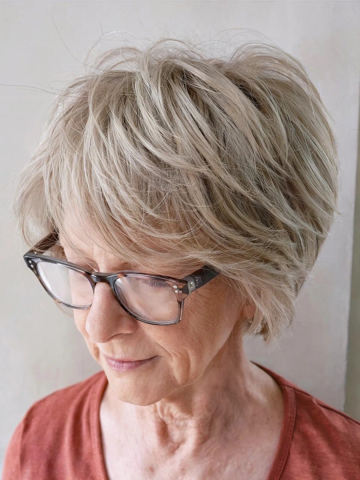 Tousled razor cut bob with glasses