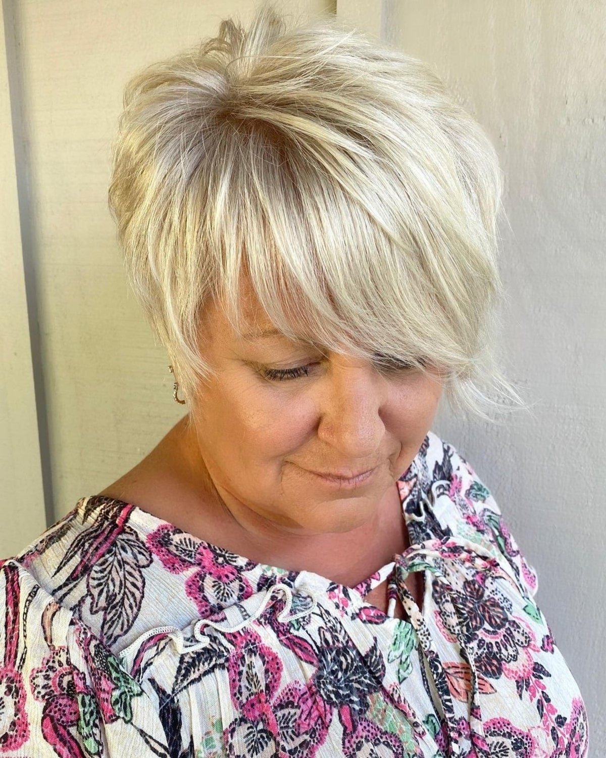Long -like pixie with the side bangs of women over sixty