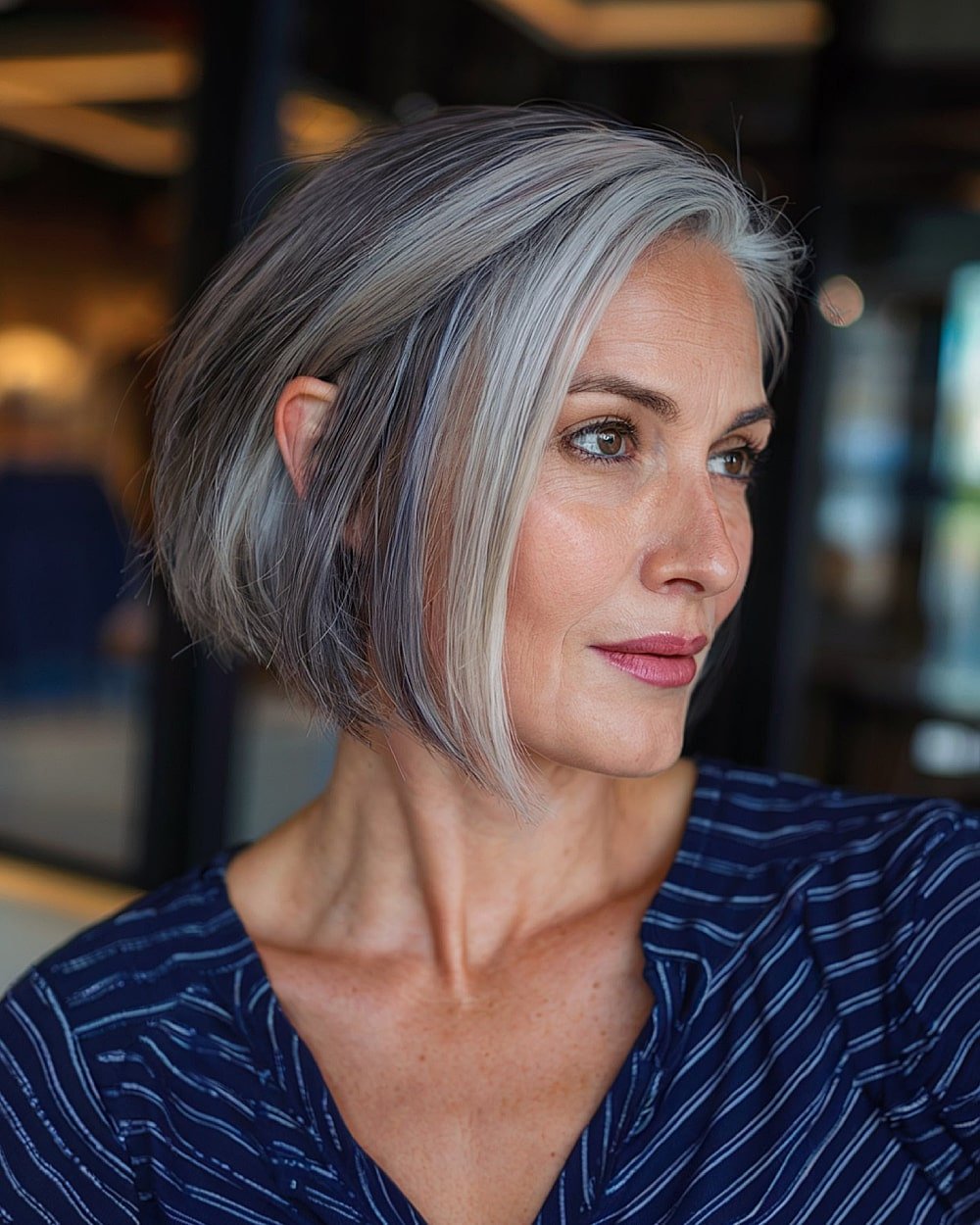 Angled bob with icy grey panels framing the face on a cool-toned dark base