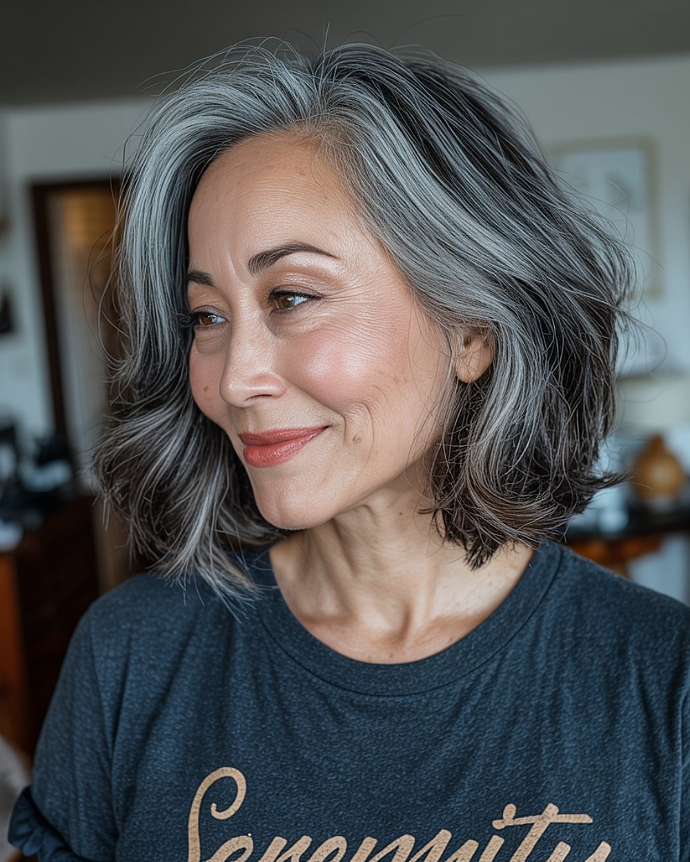 Wavy lob with ash grey balayage highlights over dark base for soft grey blending