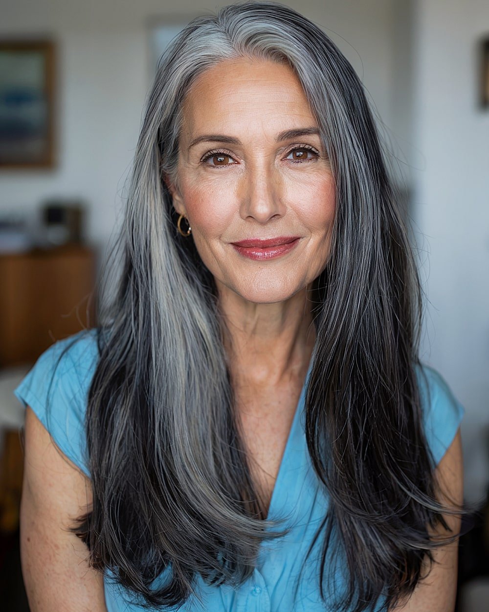 Long layered haircut with smokey grey highlights blended into dark hair