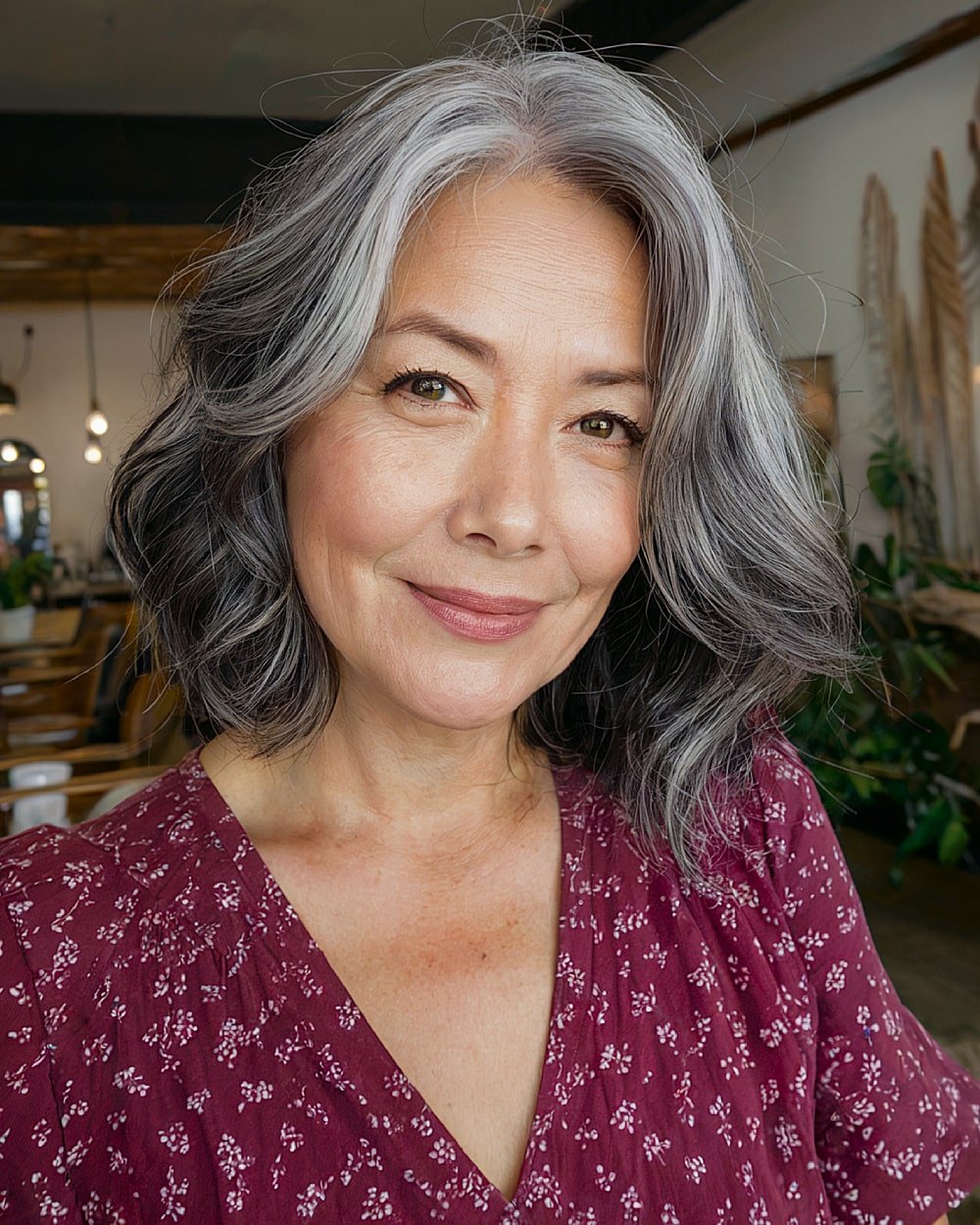Dark layered haircut with silver root fade and soft waves for natural grey blending