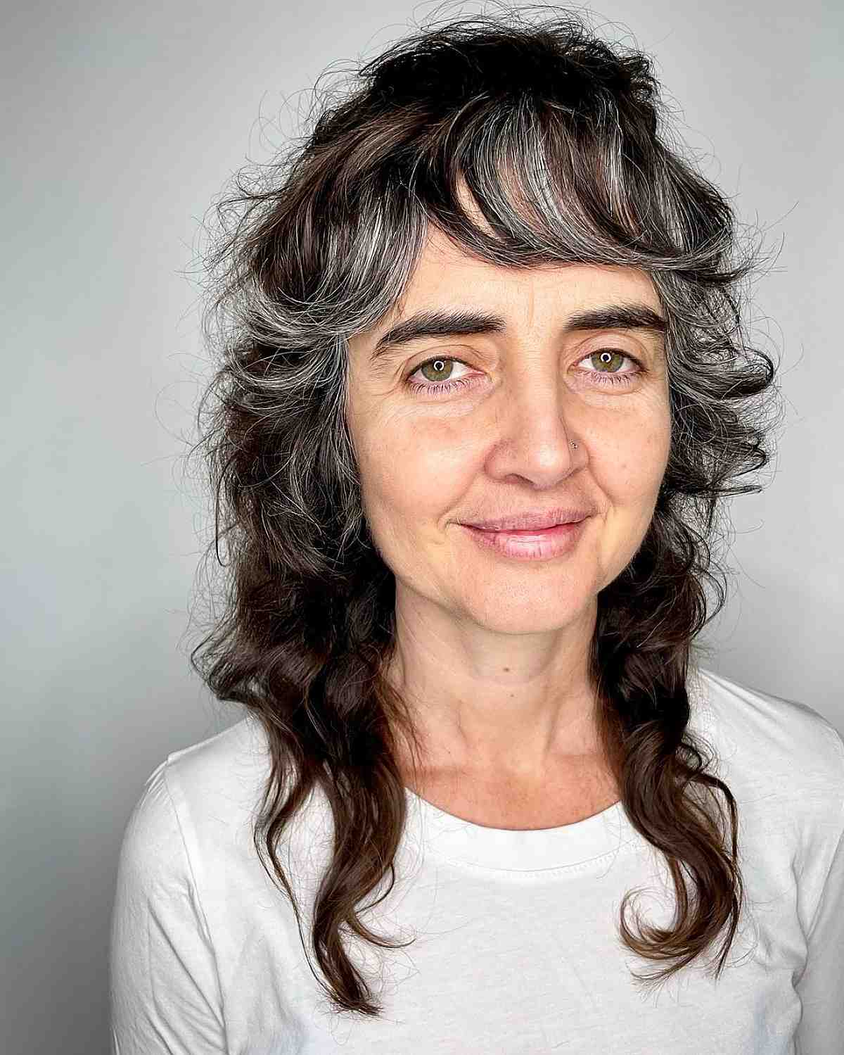 Medium length curly with explosions for dark hair