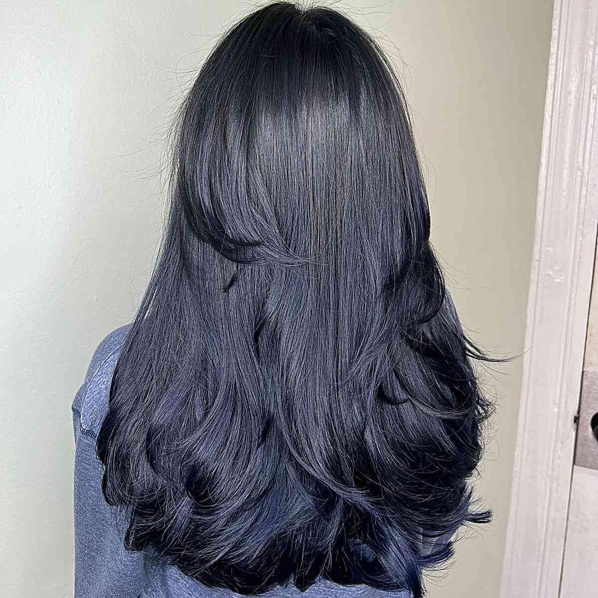 Long -term black hair with soft dark blue color