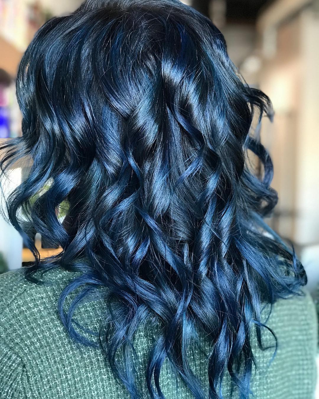 Glossy curly dark blue hair color