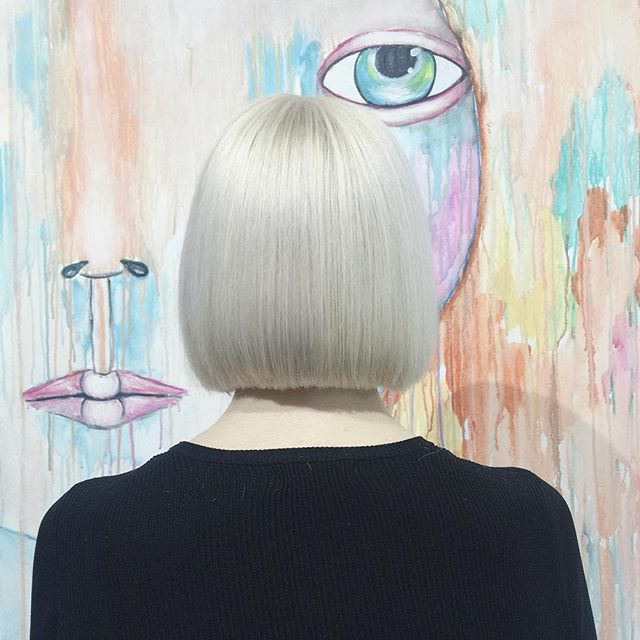 Back view of the short blonde hair cutting of women