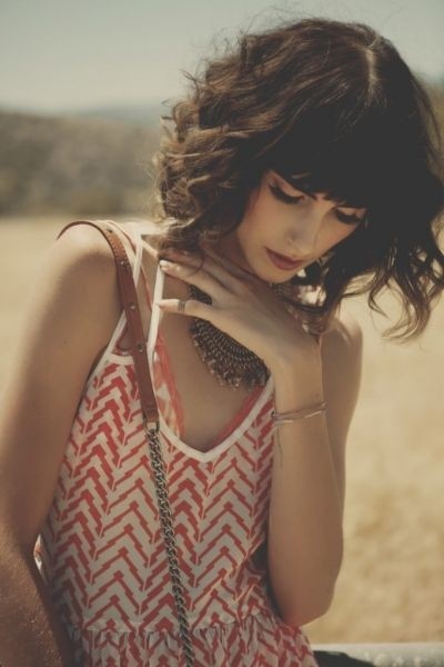 Very short curly hair style with sharp bangs