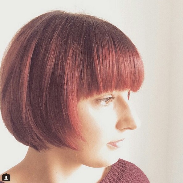 Cut a cute red bob hair cut with sharp bangs