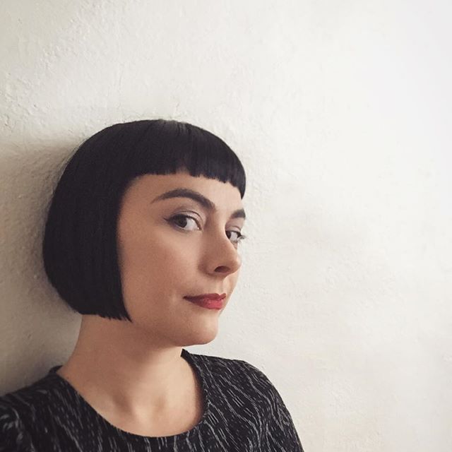 Dark short hair cut with sharp bangs