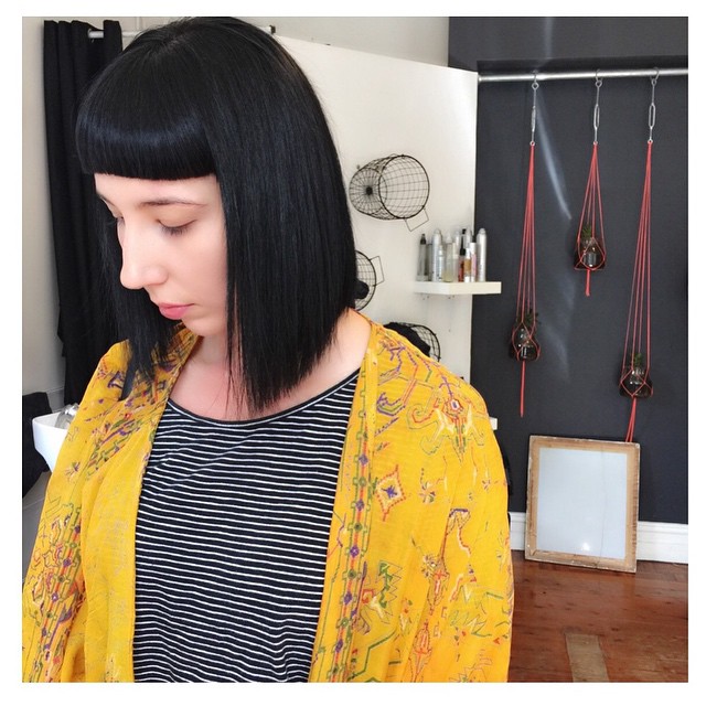 Short black bob hair cut straight with sharp bangs