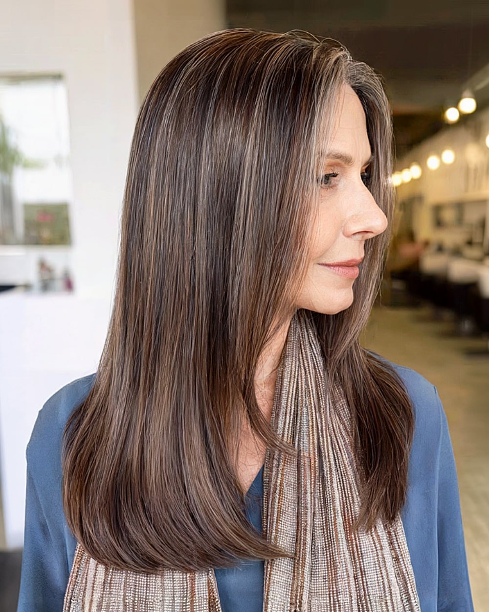 Straight long walnut brown hair with soft root shadow for women over 60