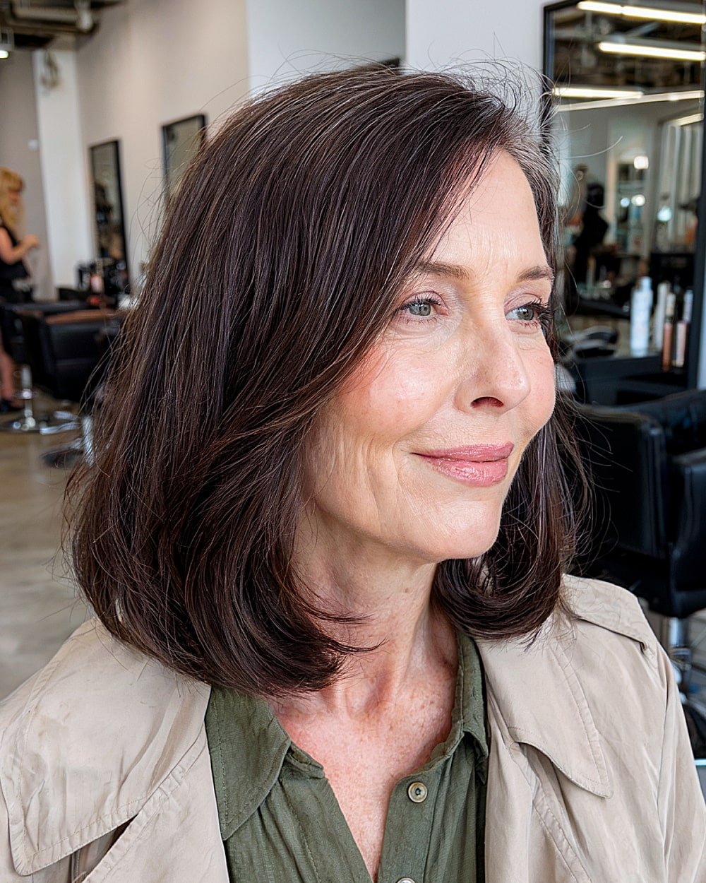 Dark chocolate brown medium cut with soft face-framing layers for women in their 60s