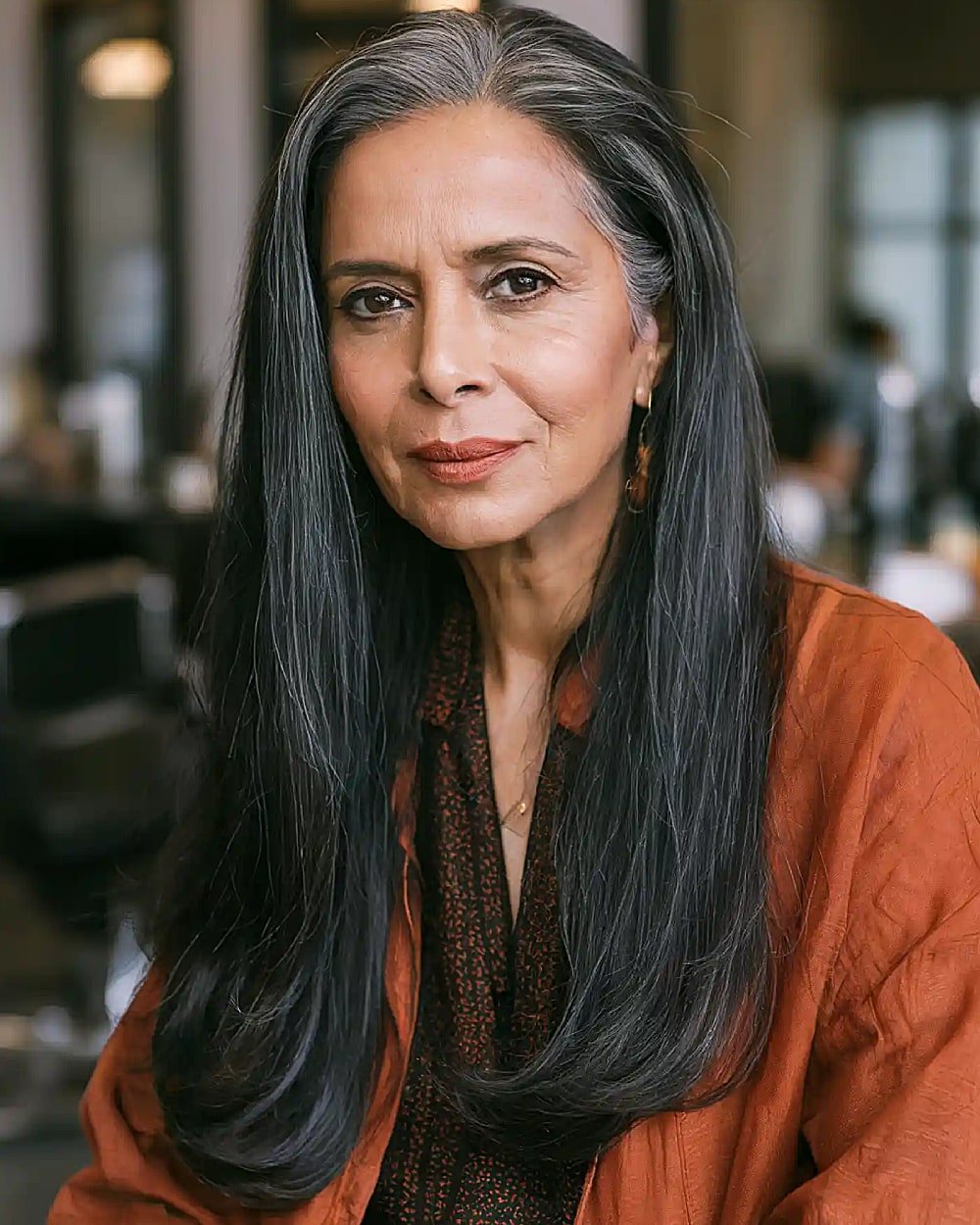 Long straight salt and pepper hair over 60 with a deep side part