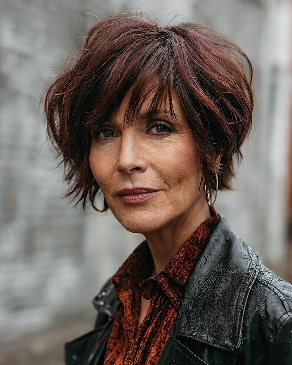 Layered choppy haircut with side part and textured bangs for older women