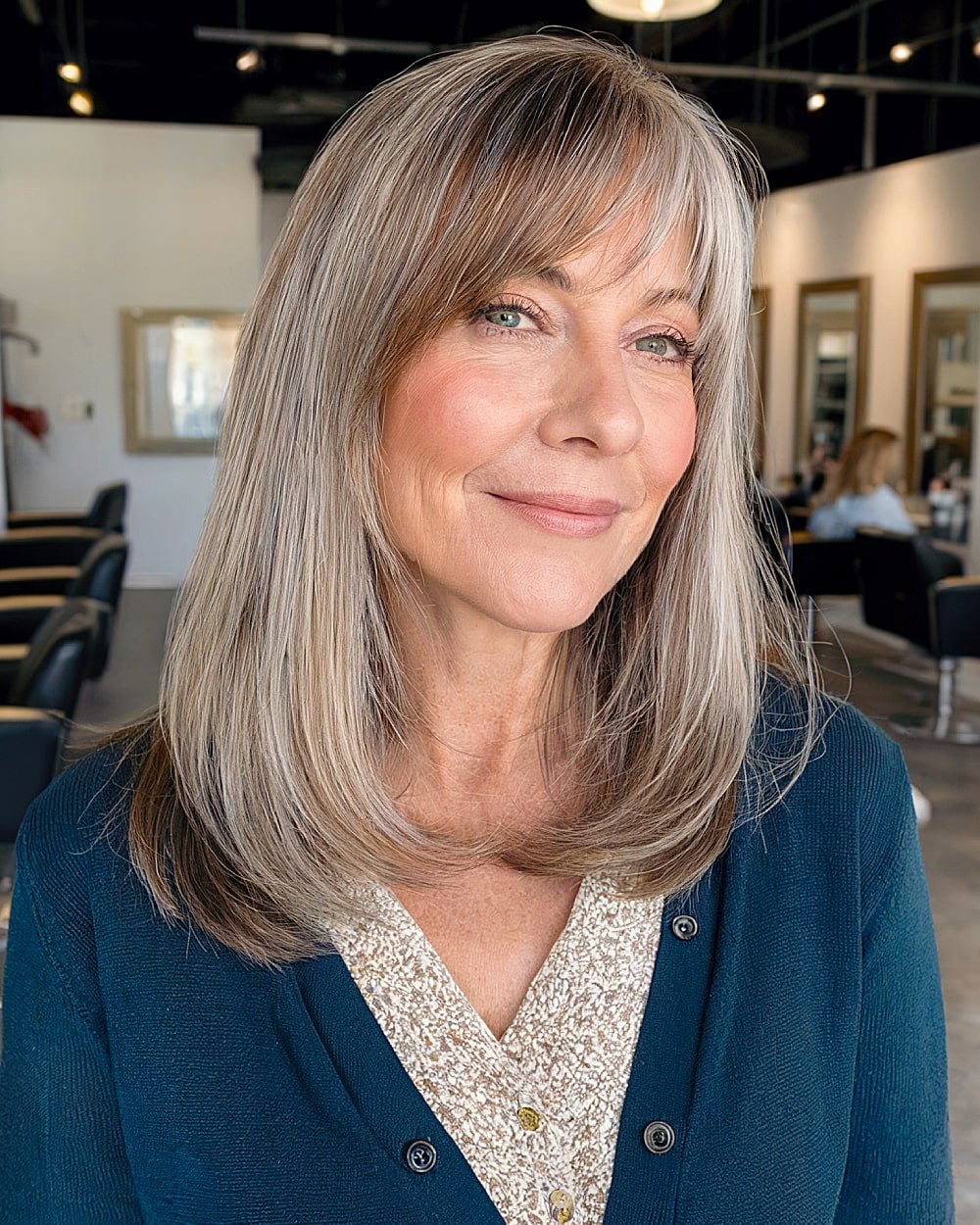 Medium hairstyle with side bangs for women over 60 with a large forehead