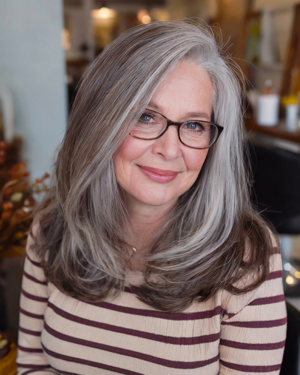 Medium length side part haircut with soft, face-defining layers for round faces over 60