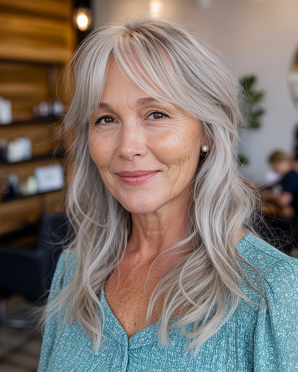 Medium length silver hair with airy curtain fringe and light layers for mature women