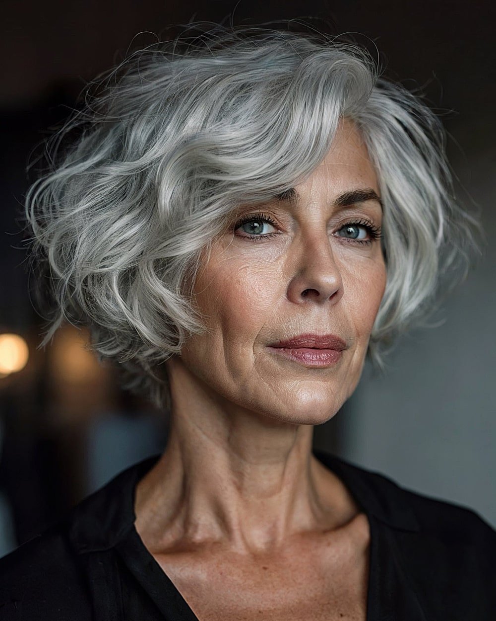 Silversway haircut with voluminous gray waves and a defined side part for women over 60