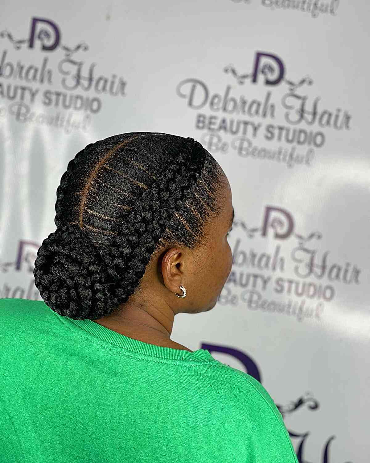 Two double braids in an updo bun with a center part