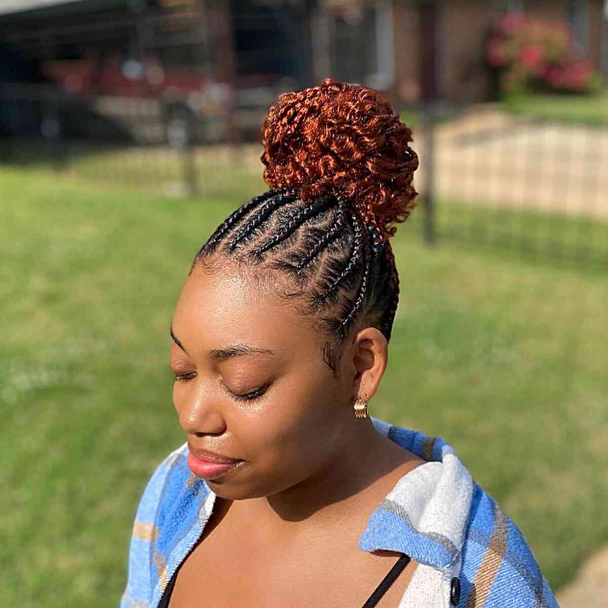 Black hair with tribal braids and a copper bun