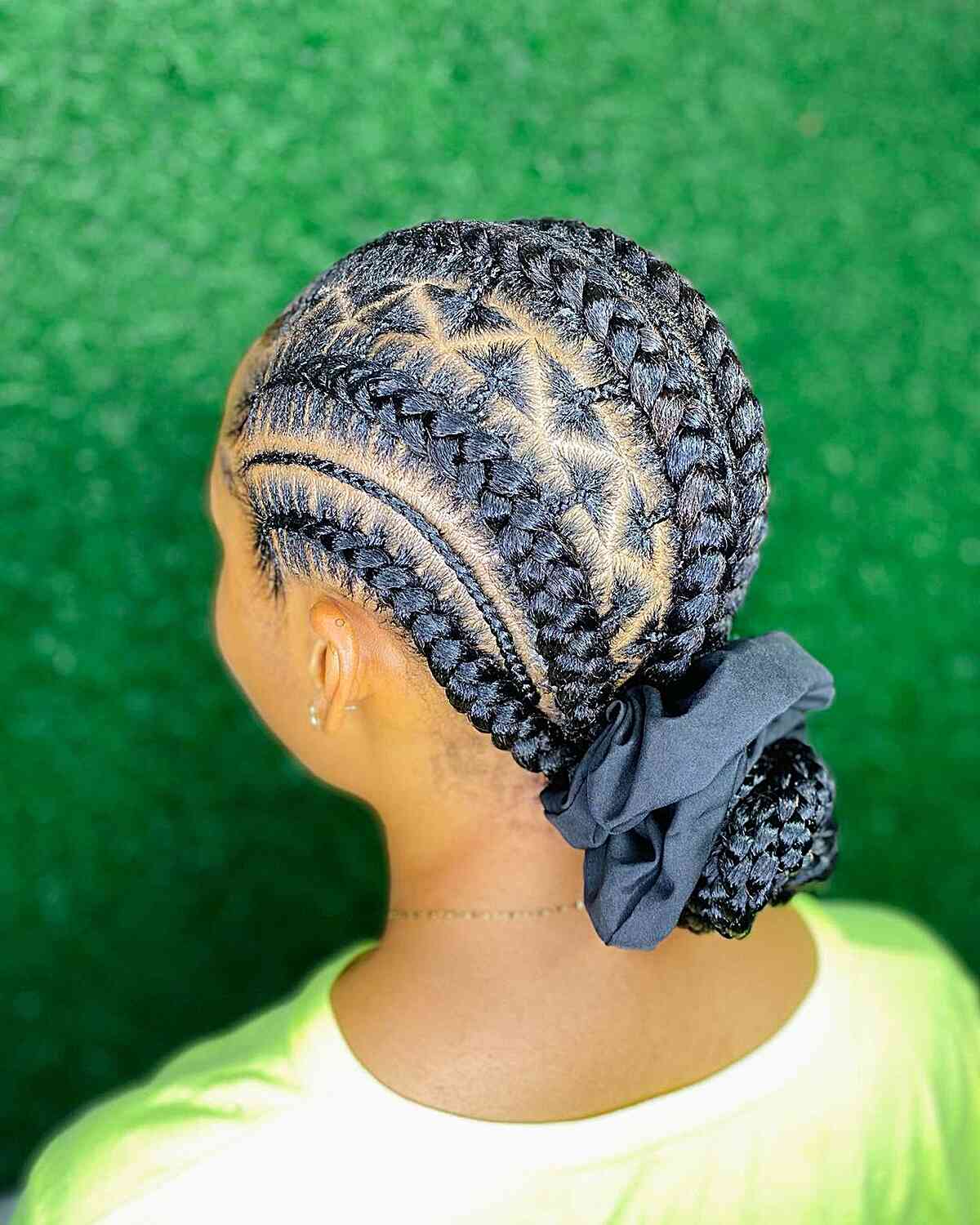 Low braided hair bun with triangle parts for black women