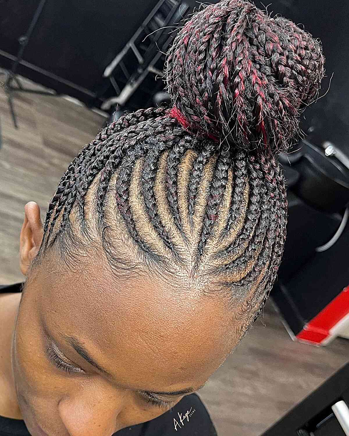Black braided bun with subtle red accents