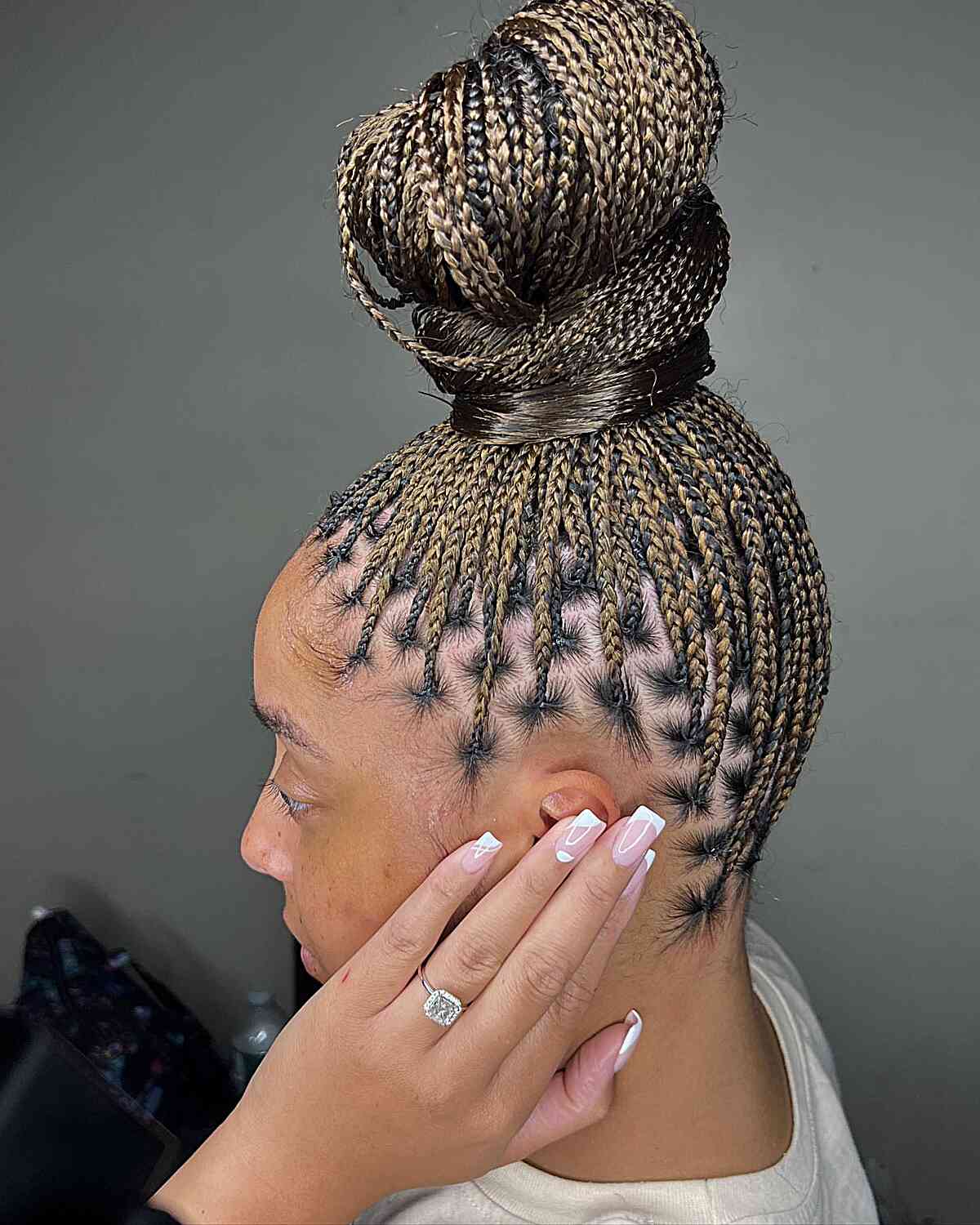 Small knotless braids with a high bun