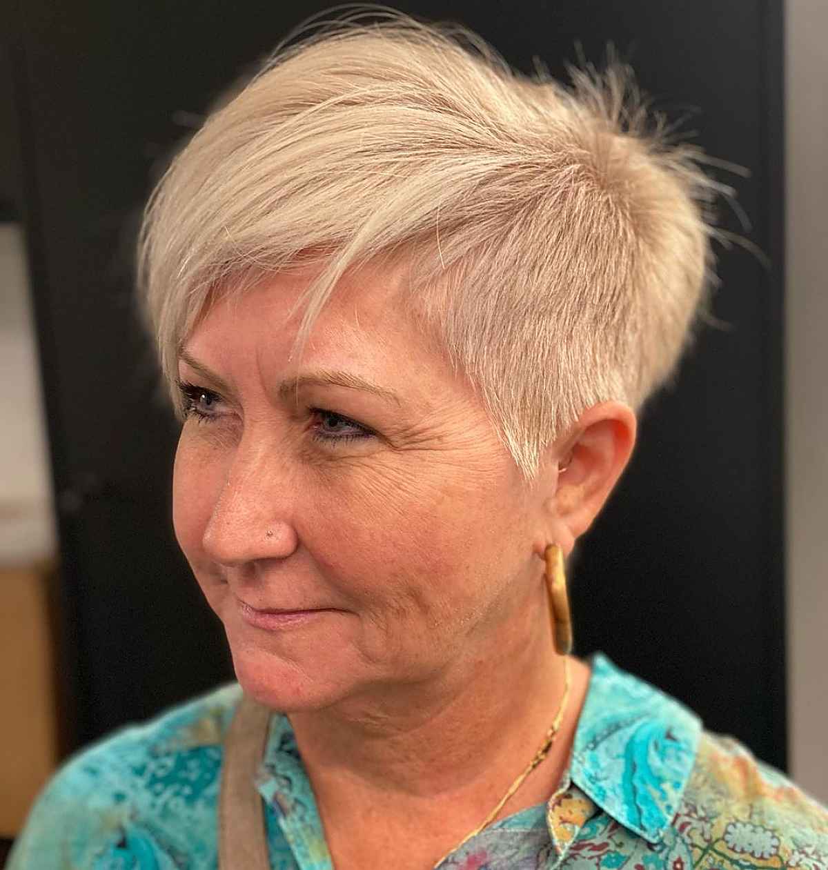 Short haircut with side bangs for women over 60 years old