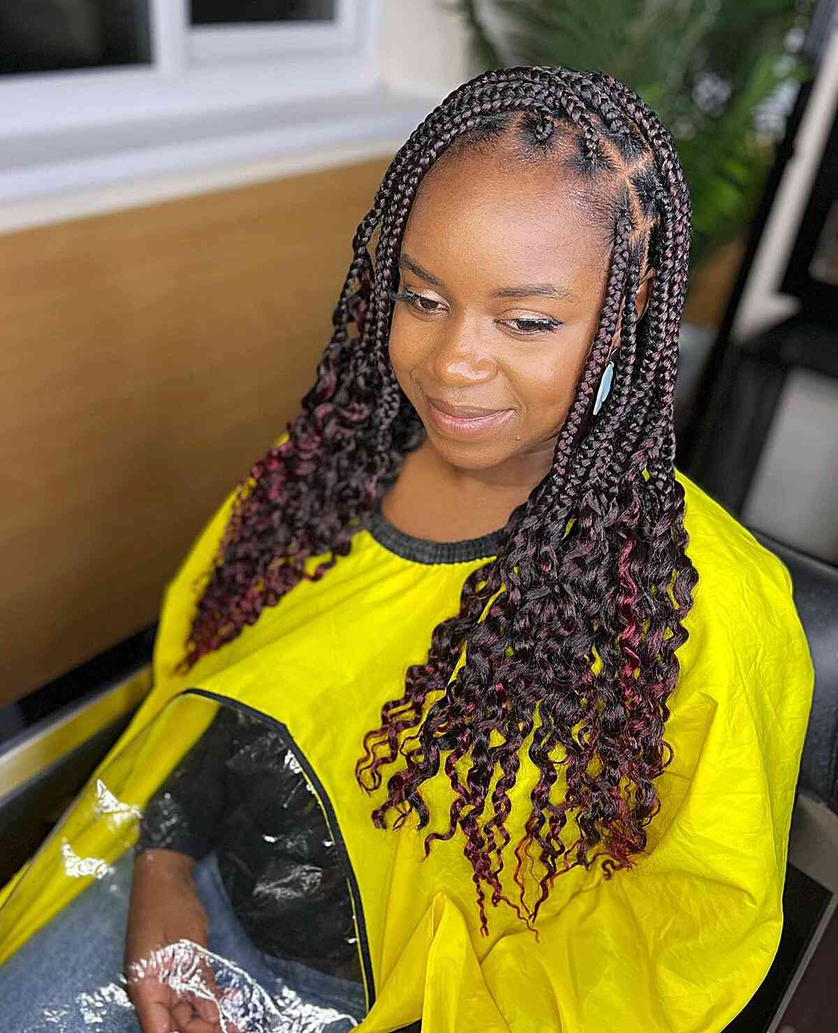 Black and burgundy medium length knotless braids with loose ends