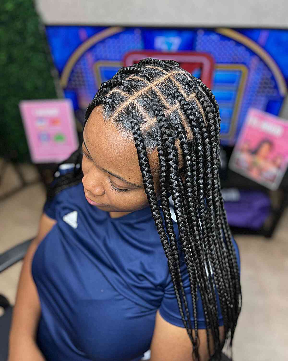 Medium length knotless braids with a middle part